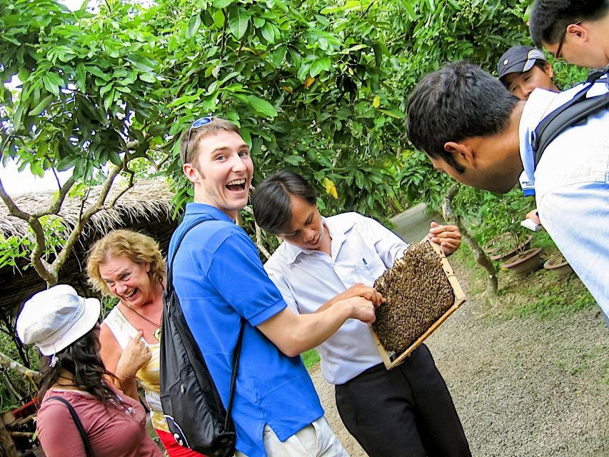 HCM: Cu Chi Tunnels & Mekong Delta with Coconut Village Tour - Coconut village visit: honey tea, fruit, and how people turn coconuts into snacks